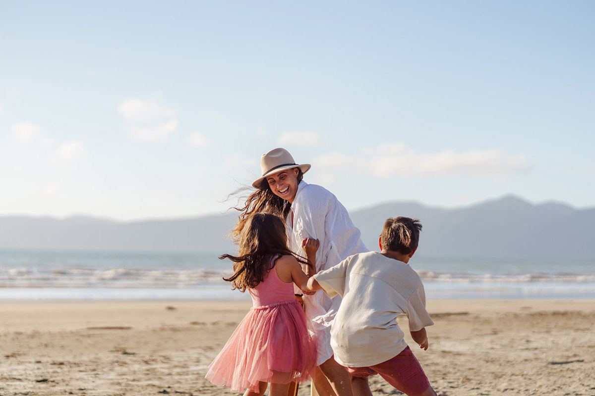 Family play beach cricket in Paraparaumu